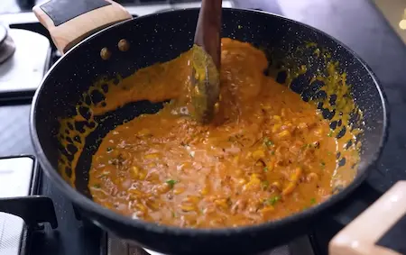 Step 5: combining sautéed corn with gravy for corn masala sabzi