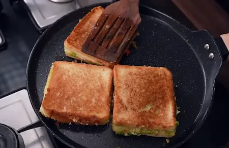Step 4: toasting the Paneer Crispy Sandwich on tawa until golden and crispy