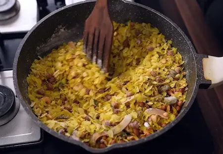 Step 4: mixing roasted nuts and seasoning in Poha Chiwda Recipe