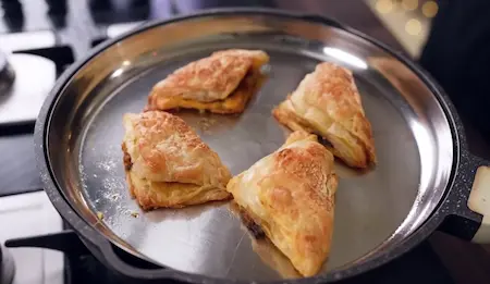 Step 7: cooking puff patties in kadhai for Canteen Style Paneer Puff