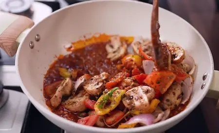 Step 5: combining tomato gravy with vegetables for Dhabe Wala Kadhai Mushroom Recipe