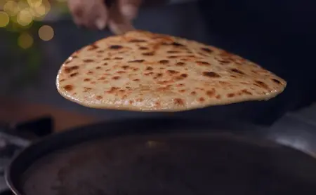 Step 5: cooking Sattu Ka Paratha on tawa until golden brown
