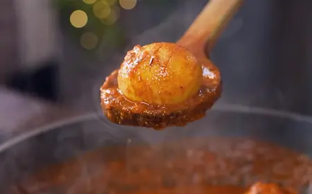 Adding eggs to curry for Lababdar Dhaba Style Egg Masala Recipe