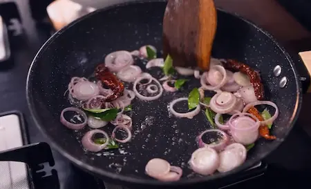 Step 5: Preparing mustard seeds, dry red chilli, shallots and curry leaves tempering for Mango Curry