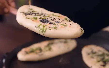 Step 6: Cooking kulcha on hot tawa with steam for Peepé Wale Chole Kulche