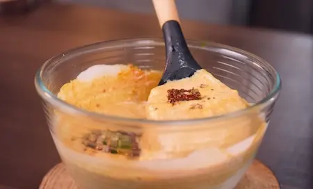 Step 7: Cooking spiced dahi gravy on low flame for Creamy Dahi Baingan