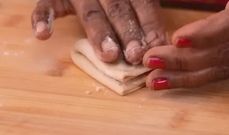 Rolling folding and shaping Ghadi Chi Poli into layered flatbread for Konkan Veg Thali