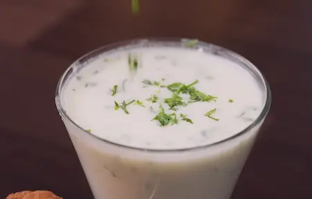 Chilled spiced chass with jeera powder, ginger and coriander served alongside Aligarh Kachori