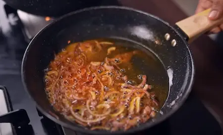 Step 8: Preparing second ghee tadka with cloves and onions for Burhanpuri Dal