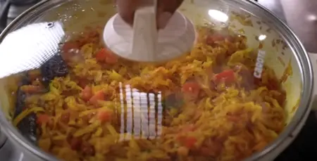 Adding coriander powder, red chilli powder, and amchur to the papaya sabji.