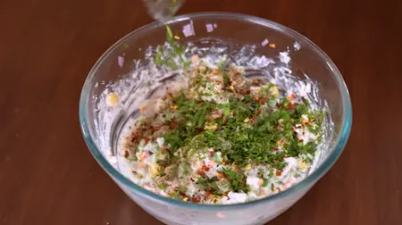  Adding spices, herbs, and baking soda to the batter for seasoning and fluffiness.