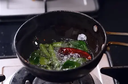 Preparing tadka for red coconut chutney