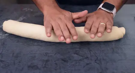 Shaping the dough into a log for Pinwheel Aloo Paratha