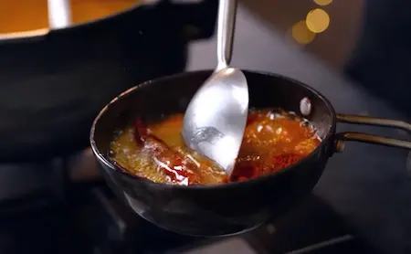 Tadka preparation with spices in small pan