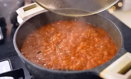 Preparing the tari with spices and soaked brown chana for Nagpur Special Tari Poha