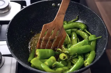 Step 4 sautéing bhavnagri chillies for dahi mirchi ki sabji
