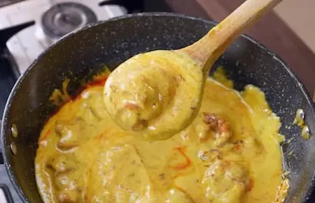 Step 6: adding pakodas to Cauliflower Mustard Kadhi Recipe