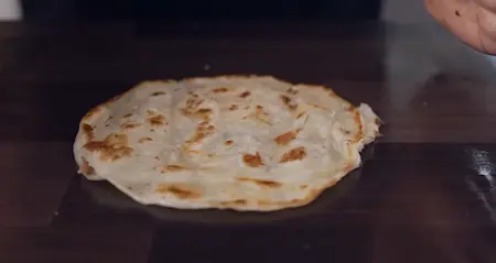 Step 5: Cooking crispy flaky Malabari Paratha to pair with Paneer Pepper Fry