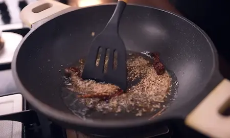 Step 6: Preparing tadka with mustard seeds and sesame for Dudhi Muthiya
