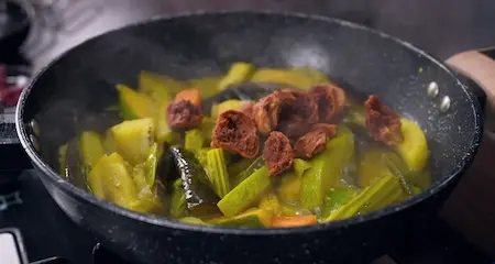 Step 7: Adding fried moong dal wadi back into Bengali Niramish Jhol