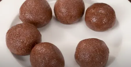 shaping the ragi mixture into ball with adding ghee