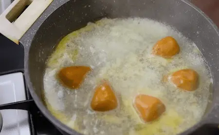 Shaped and boiled gatte floating in water.