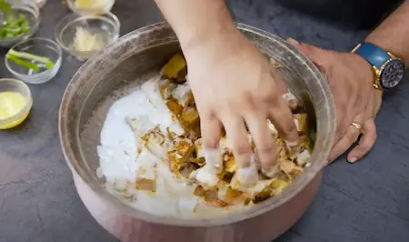 Fried yam layered with spices and curd in the pan