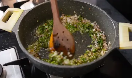 Adding Vatan and spices to onion mixture for Spicy Aloo Sabji