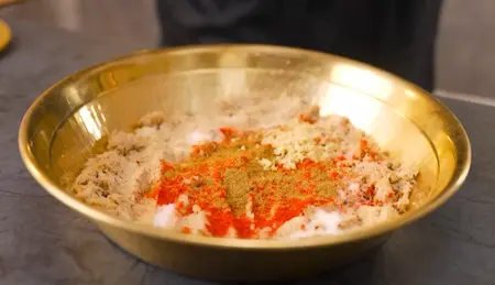 Mixture of soya, spices, and potato being combined into a dough