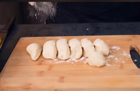 Shaping and stuffing buns with cheese and vegetables