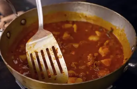 Simmering Aloo Chana Sabzi to blend flavors