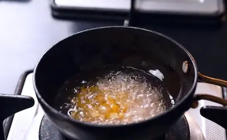 Preparing tempering for ginger pachadi with dals and mustard seeds