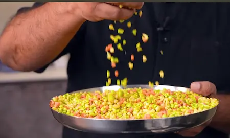 Frying tri-colored boondi in hot oil for ladoo preparation