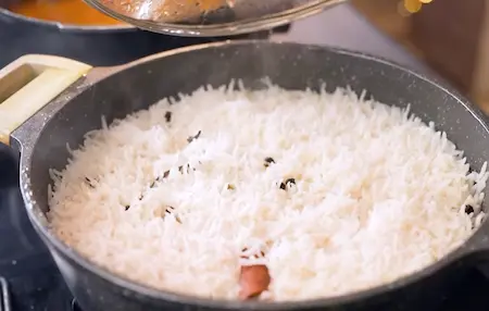 Rice cooking with spices in pot