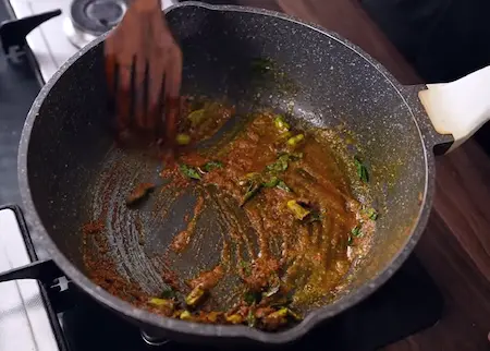 Step 2: tempering green chilies, curry leaves, and spices for Poha Chiwda Recipe