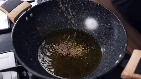 Step 3 tempering mustard oil with panch phoron for dahi mirchi ki sabji