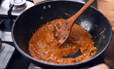 Step 4: adding curd mixture to gravy for Papad ki Sabji Recipe