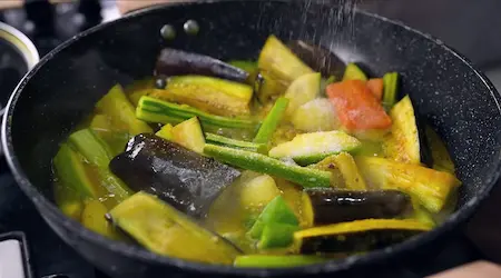 Step 6: Cooking Niramish Jhol covered on medium heat with ginger-chilli paste
