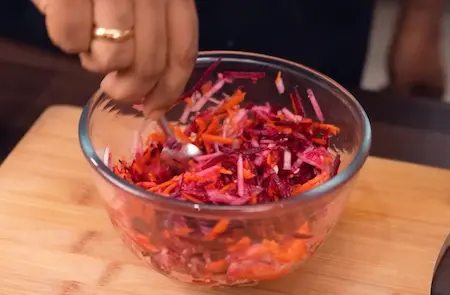 Mixing grated carrot beetroot and cucumber with salt and sugar for Koshimbir in Konkan Veg Thali
