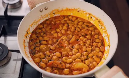 Step 6: Adding bhujiya shing peanuts to the masala gravy for Bhujia Shing Ki Sabzi