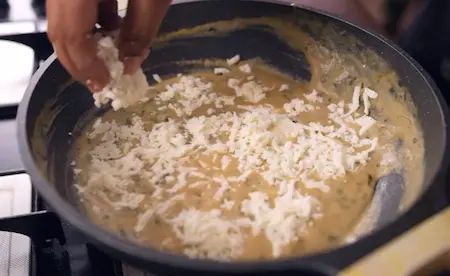 Step 5: Adding grated and triangle paneer to Paneer Kasuri Methi gravy