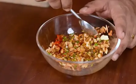 Mixing cashews, raisins, and spices for stuffing.