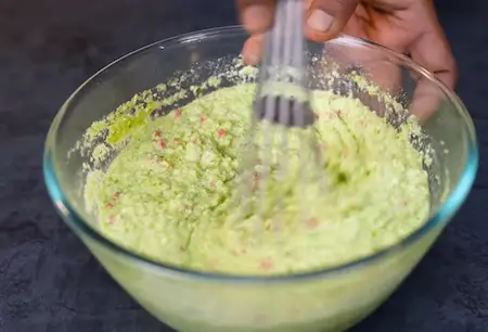 Mixing the idli batter with green pea paste