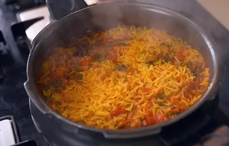 Pressure cooking the rice in a cooker