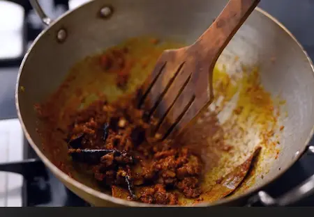 Spices being added to the pan