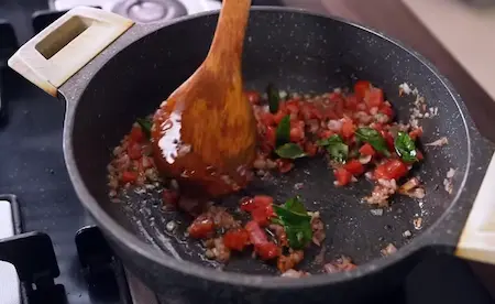 Step 2: tempering with mustard seeds and onions for Maharashtrian Style Kaju Sabji