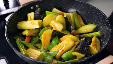 Step 5: Adding salt and turmeric to vegetables for Niramish Jhol Bengali recipe