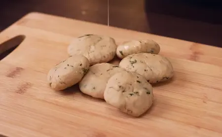 Step 2: Rolling dough into thick discs for shaping Aligarh Kachori