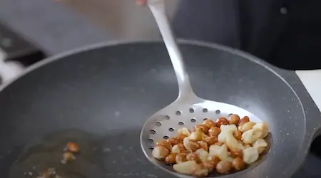 Frying peanuts and cashews for Seviyan Upma