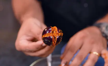 Stuffing the brinjal with a flavorful mixture